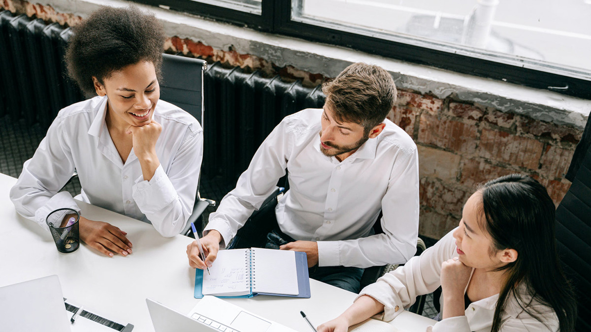 Three people having a meeting in an office.