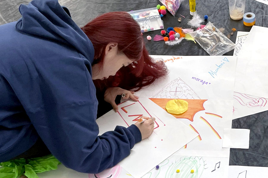 A dance student creating artwork during an MFT lesson.